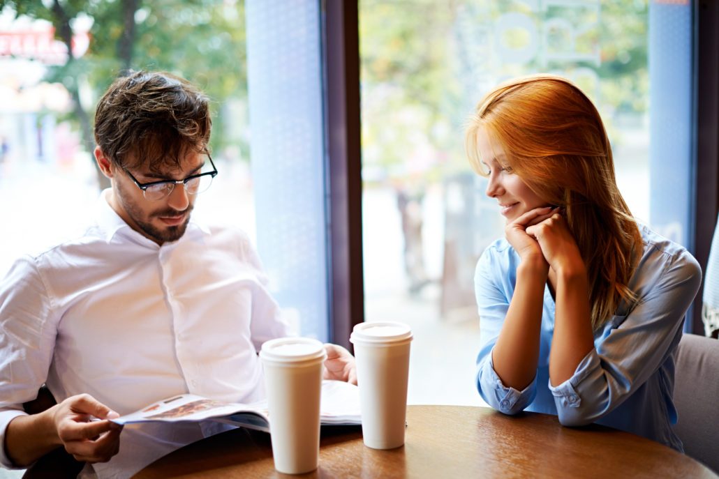 Portrait of young couple having rest in cafe